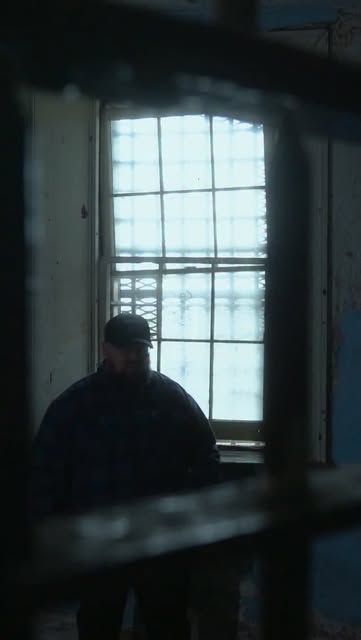 Dicko silhouetted in front of a window during the video shoot