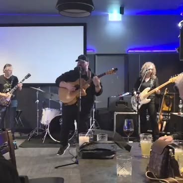 Dicko playing acoustic guitar with Riffs and Bones