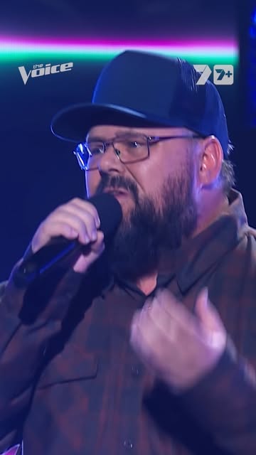 Dicko singing into a microphone on The Voice Australia